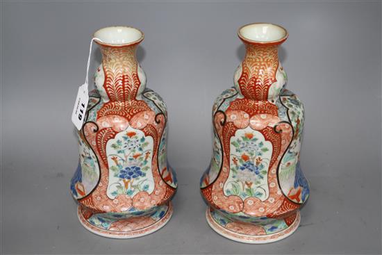 A pair of Japanese enamelled porcelain huqqa base vases, decorated with figures, height 25cm